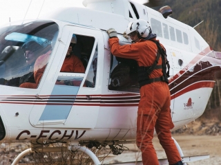 clinging to the heli